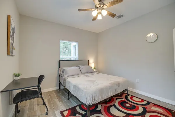 a bedroom with a bed and a chandelier