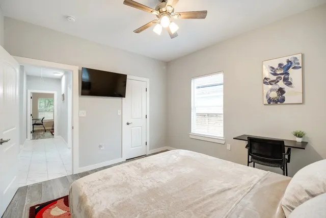 a bedroom with a bed and a flat screen tv