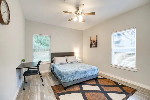 a bedroom with a bed and a window