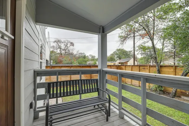 a view of a wooden balcony with a bench