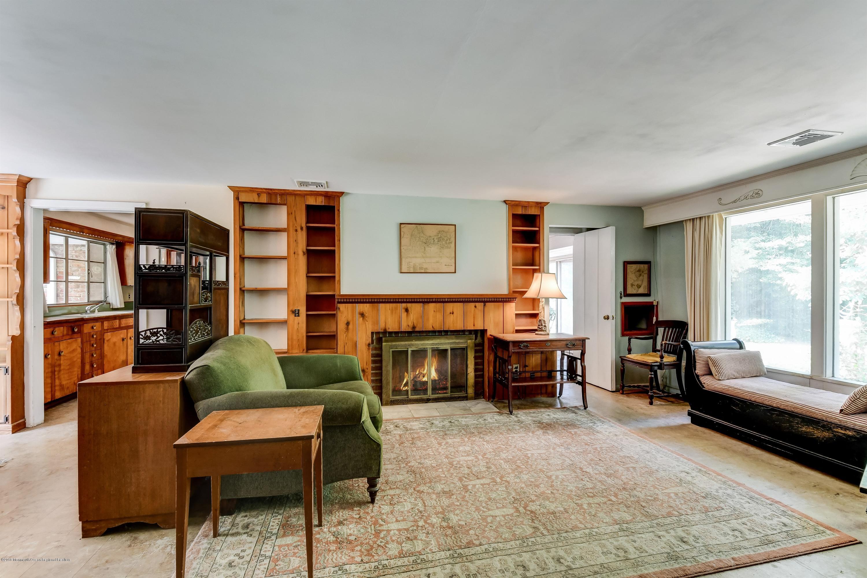609 Locust Point Road Atlantic Highlands, NJ 07716 - Photo 6 of 23 a living room with furniture and a fireplace