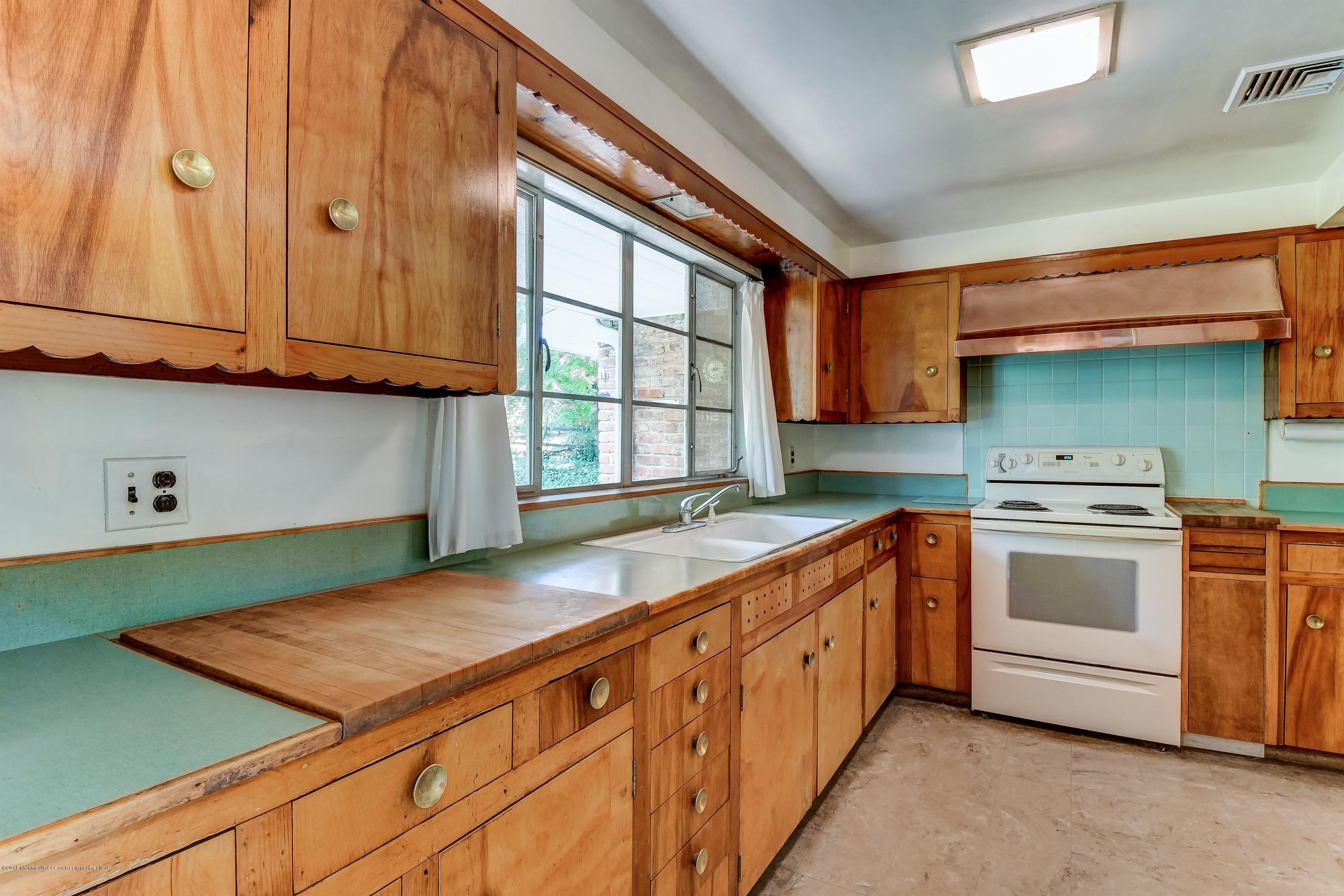 609 Locust Point Road Atlantic Highlands, NJ 07716 - Photo 8 of 23 a kitchen with a stove and a sink