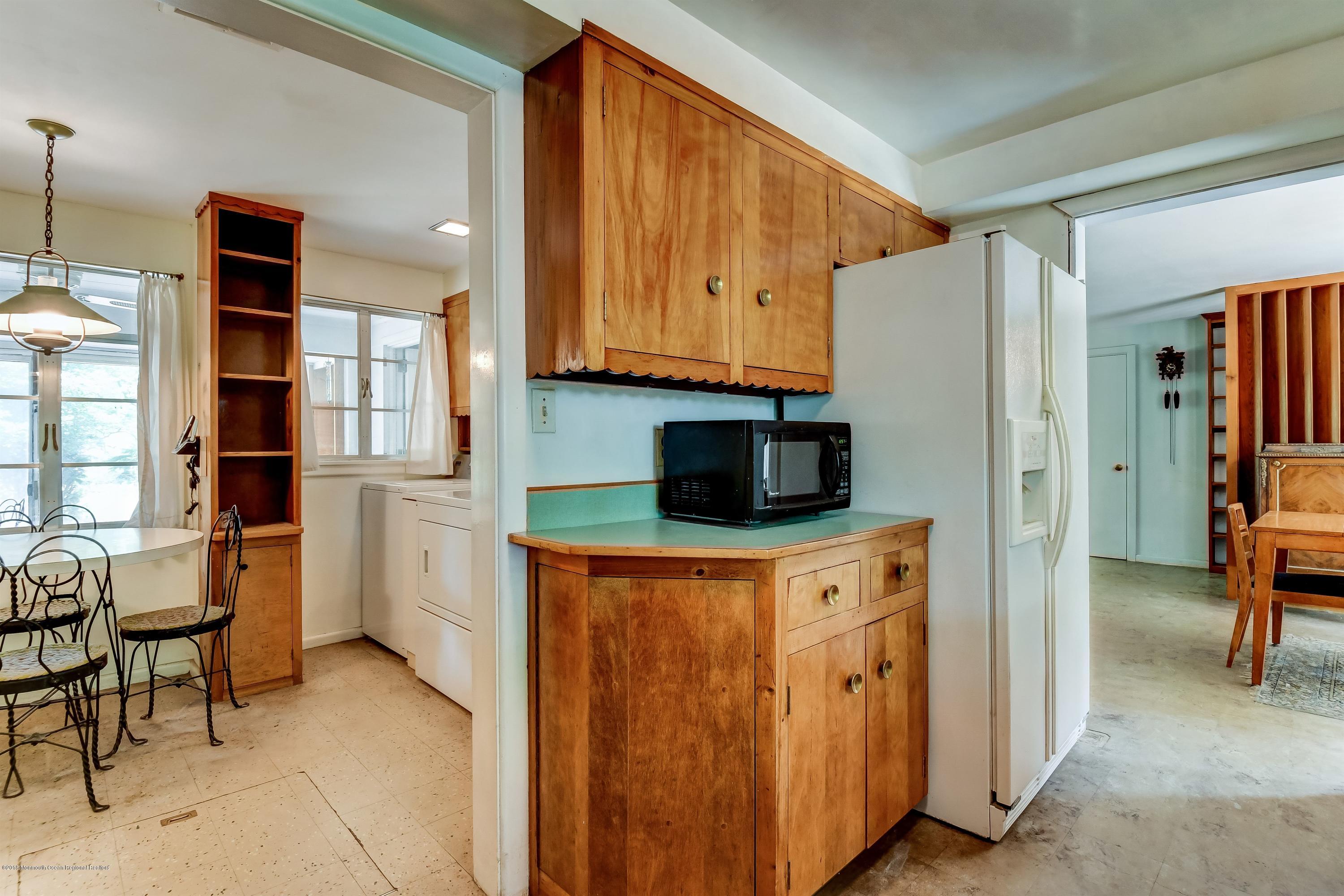 609 Locust Point Road Atlantic Highlands, NJ 07716 - Photo 9 of 23 a kitchen with stainless steel appliances a refrigerator sink and cabinets
