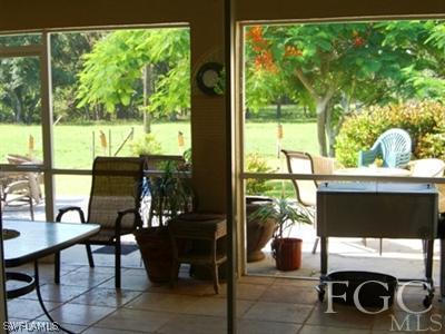 12180 Coyle Road Fort Myers, FL 33905 - Photo 2 of 8 a dining room with furniture and a floor to ceiling window