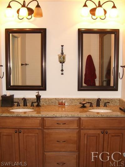 12180 Coyle Road Fort Myers, FL 33905 - Photo 4 of 8 a bathroom with a sink and a mirror