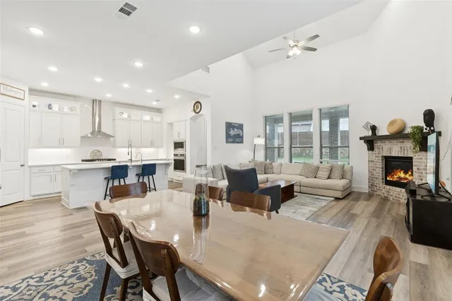 a living room with furniture dining table and a fireplace