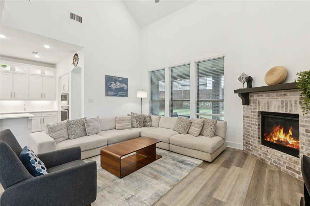 4313 Expedition Drive Oak Point, TX 75068 - Photo 15 of 40 a living room with furniture and a fireplace