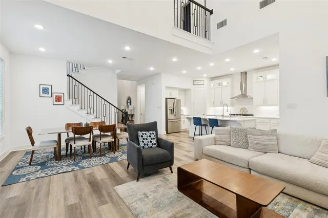 a living room with furniture and a dining table with kitchen view