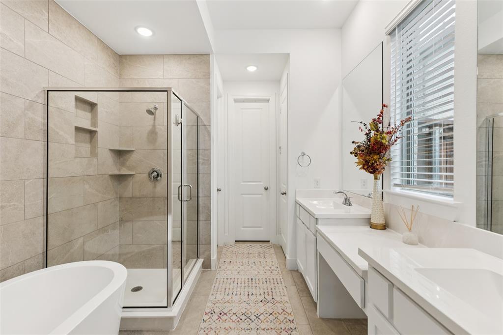 4313 Expedition Drive Oak Point, TX 75068 - Photo 21 of 40 a bathroom with a double vanity sink toilet and shower