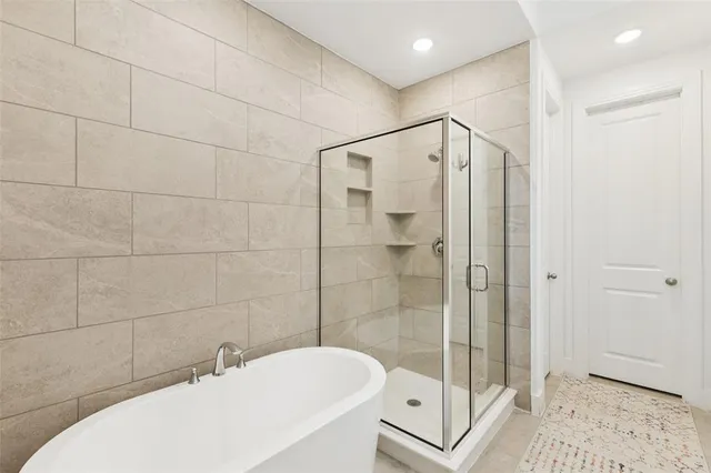 a bathroom with a bathtub a toilet and a shower