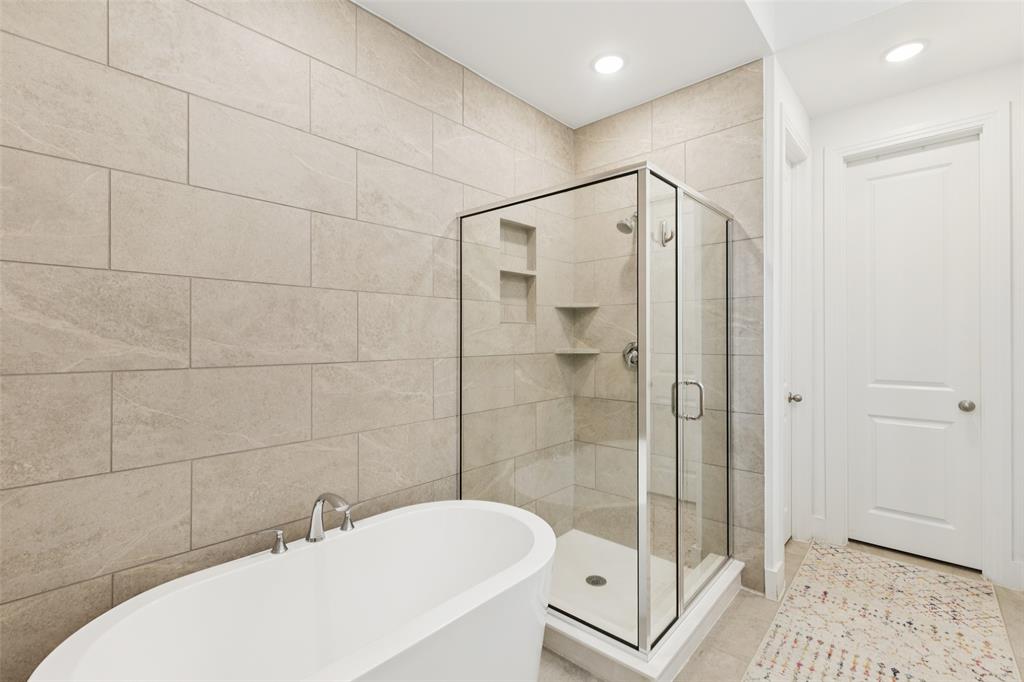 4313 Expedition Drive Oak Point, TX 75068 - Photo 23 of 40 a bathroom with a bathtub a toilet and a shower