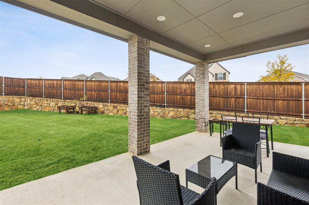 4313 Expedition Drive Oak Point, TX 75068 - Photo 31 of 40 a view of a patio with table and chairs a barbeque with wooden fence