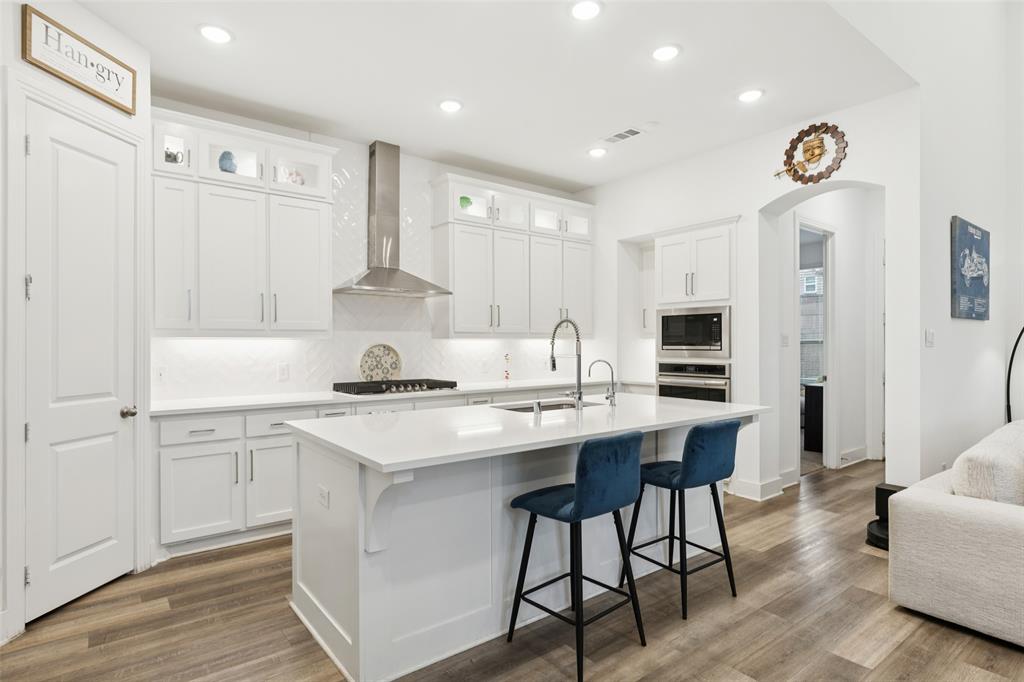 4313 Expedition Drive Oak Point, TX 75068 - Photo 8 of 40 a kitchen with stainless steel appliances a stove a sink dishwasher and a refrigerator