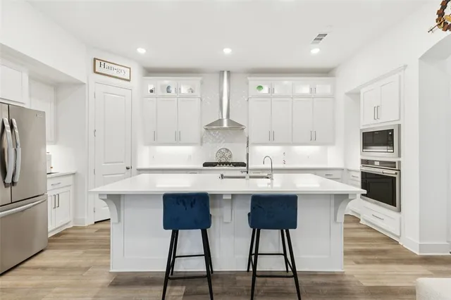 a kitchen with stainless steel appliances a sink stove and refrigerator