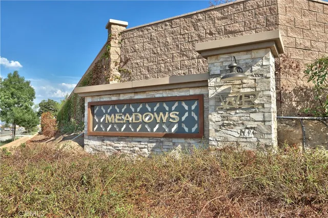 a view of a kitchen with wooden floor electronic appliances and window