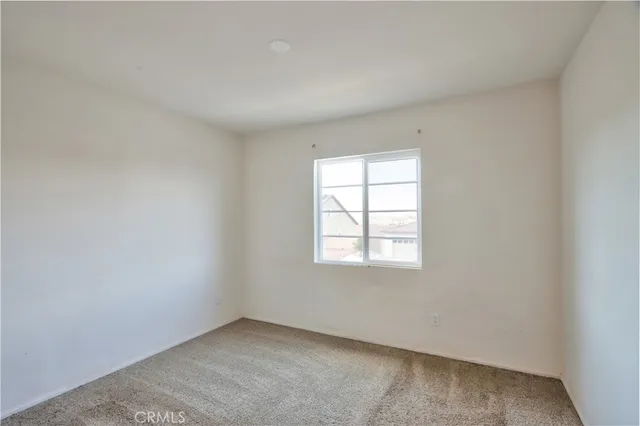 a view of an empty room and a window