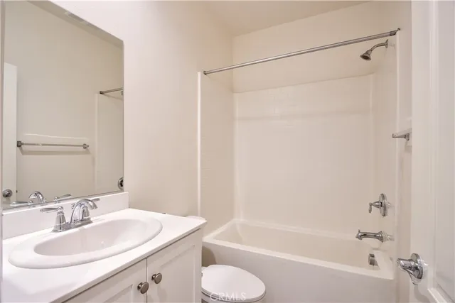 a view of a dry yard with wooden fence