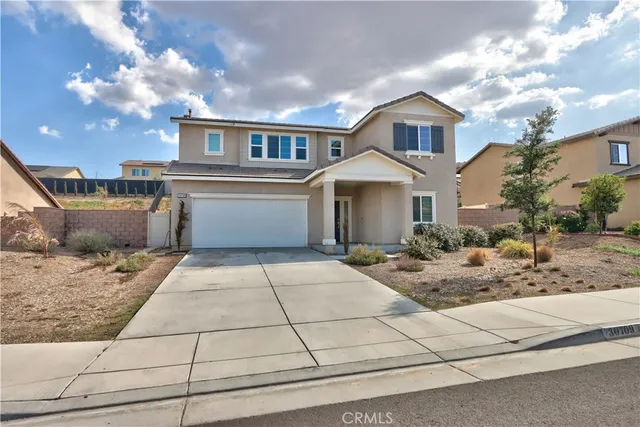 a view of a patio with a table and chairs under an umbrella