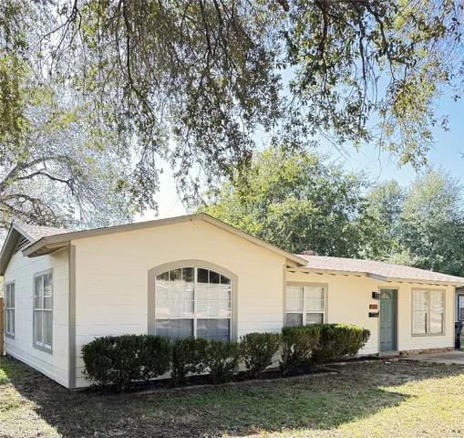 a house with a tree in front of it