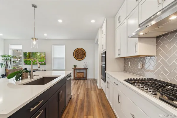 a kitchen with a sink a stove and cabinets