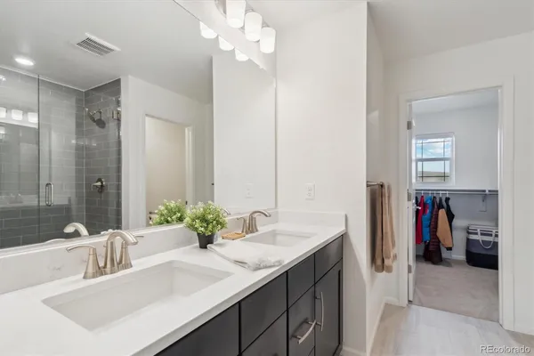 a bathroom with a shower sink and mirror