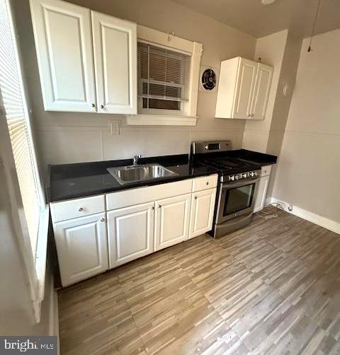 407 Cambria Street Baltimore, MD 21225 - Photo 2 of 13 a kitchen with granite countertop white cabinets and sink