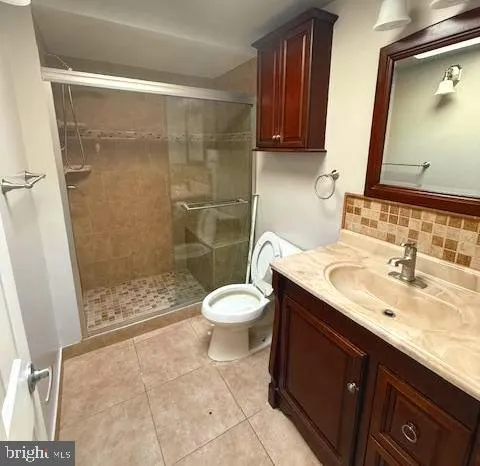 a bathroom with a sink toilet a mirror and shower