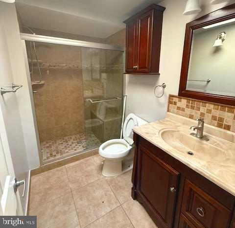 407 Cambria Street Baltimore, MD 21225 - Photo 9 of 13 a bathroom with a sink toilet a mirror and shower