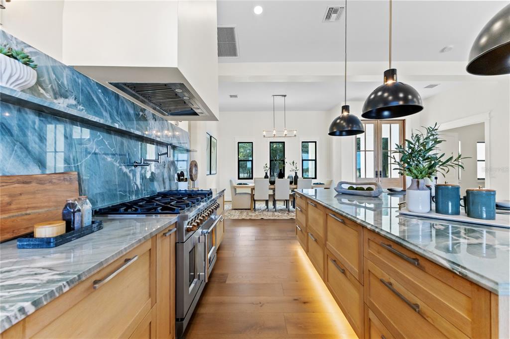 4940 Wauchula Road Myakka City, FL 34251 - Photo 14 of 77 a kitchen with stainless steel appliances granite countertop a stove a sink and a wooden floors