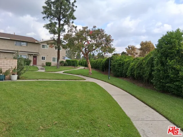 a front view of a house with a yard and trees
