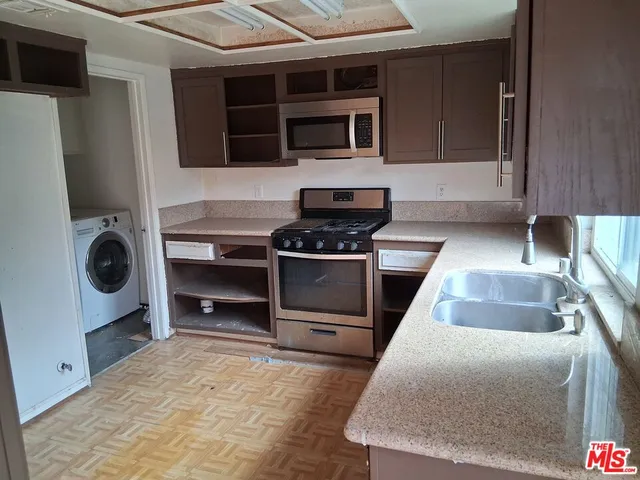 a kitchen with a stove and a microwave