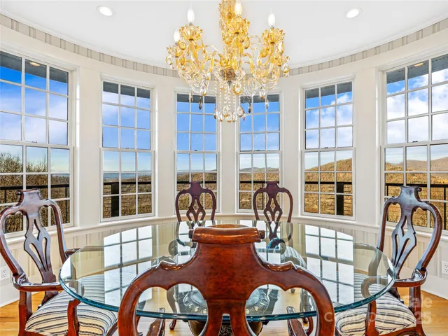 a view of a dining room with furniture and chandelier