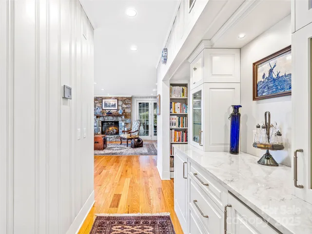 a kitchen with stainless steel appliances granite countertop a stove and a wooden floor
