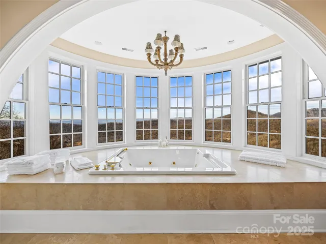 a living room filled with furniture and chandelier