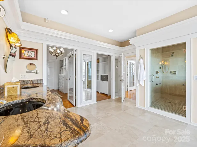 a spacious bedroom with a bed and a shower