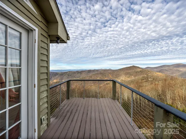a view of balcony with wooden floor and mountain view