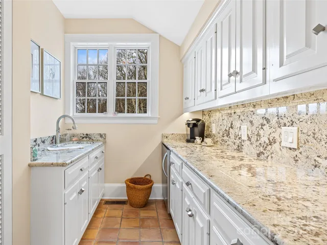 a spacious bathroom with a granite countertop sink and a granite