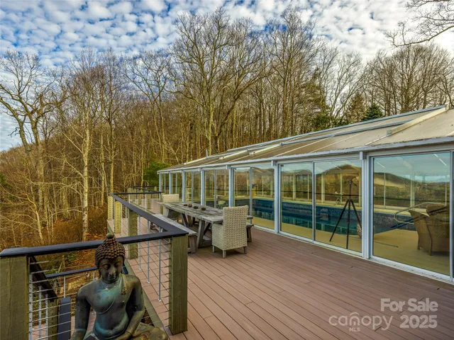 a view of a deck with couches wooden floor and fence