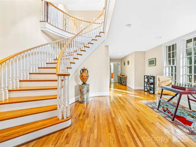 a view of entryway and hall with wooden floor