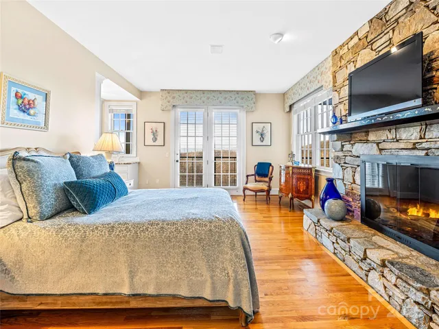a bed room with furniture and a flat screen tv