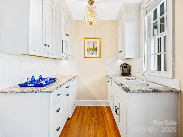 a kitchen with sink stove and cabinets