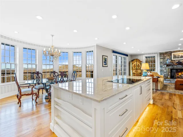 a large kitchen with lots of counter space and glass table