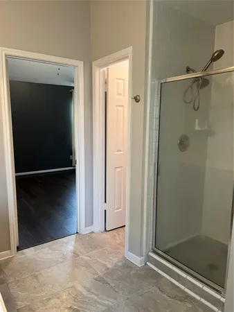 a view of a room with wooden floor and windows