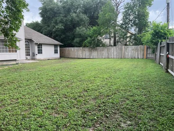 a view of a white house next to a yard