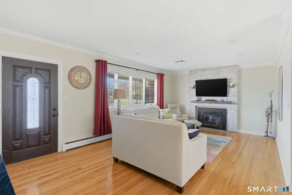 a living room with a flat screen tv and a fireplace