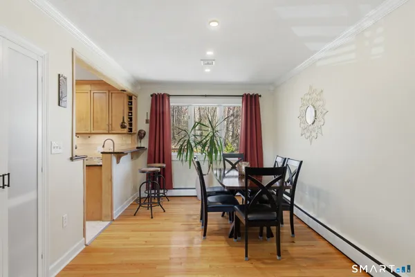 a dining room with furniture and wooden floor