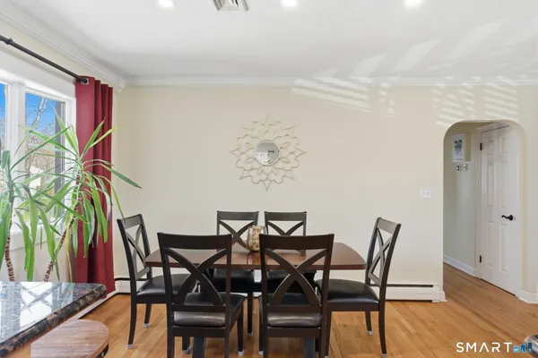 a view of a dining room with furniture and wooden floor