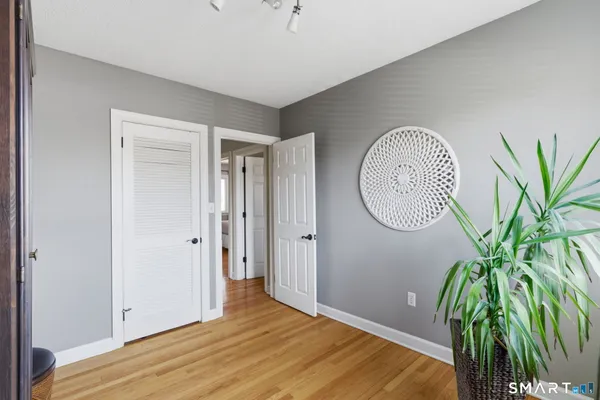 a view of a room with wooden floor and entryway