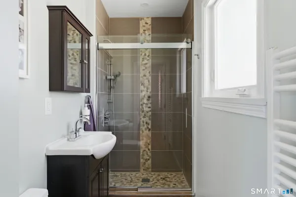 a bathroom with a sink a mirror and shower