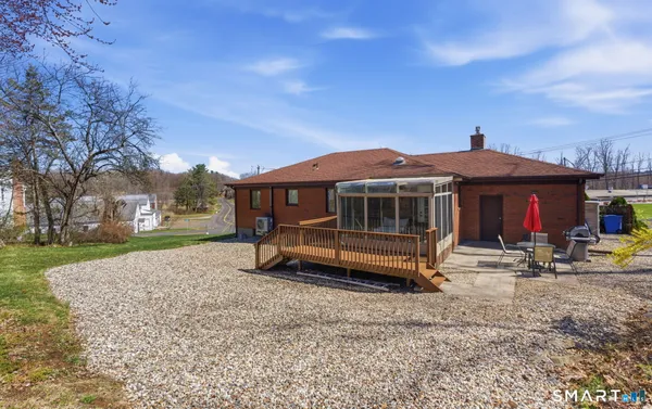 a view of a house with a yard and sitting area